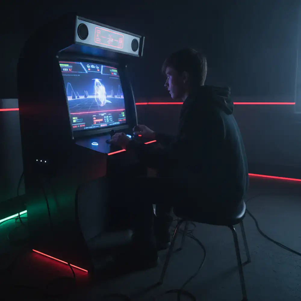 A playtester evaluating an arcade game on a monitor